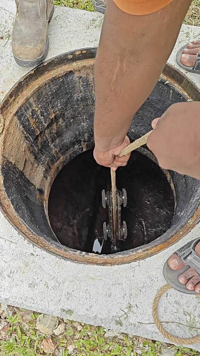 CCTV camera crawler being lowered into a manhole at a Shah Alam industrial premises